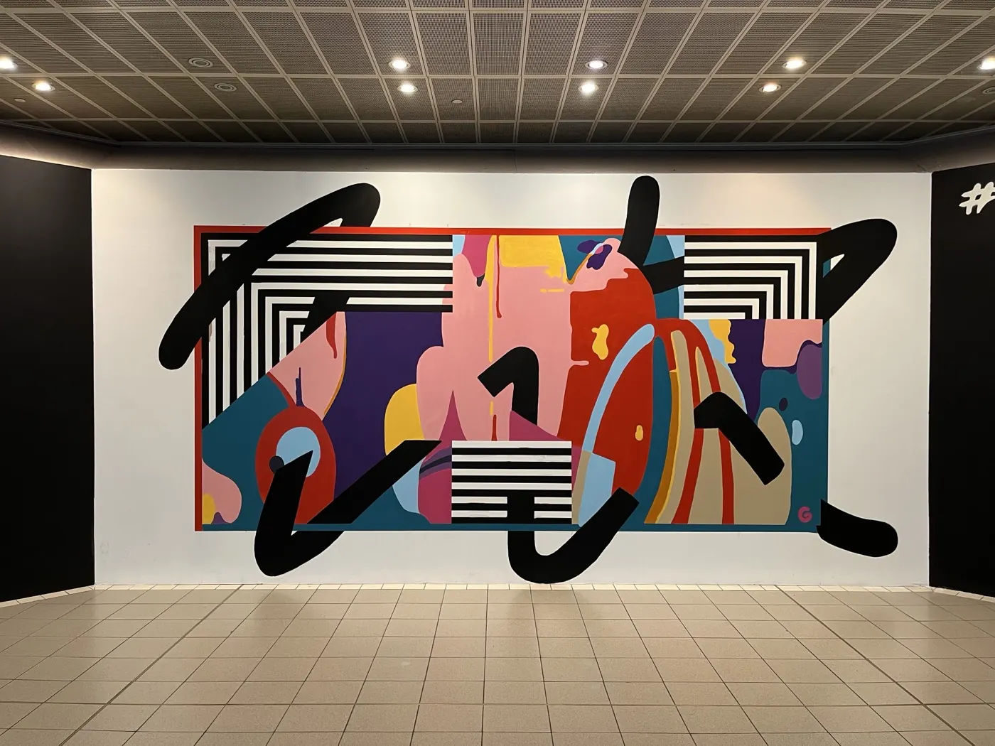 A finished CastleCourt artwork: a bold abstract collage in pink, red and teal behind sweeping black brush lettering, on a white wall in the shopping centre.