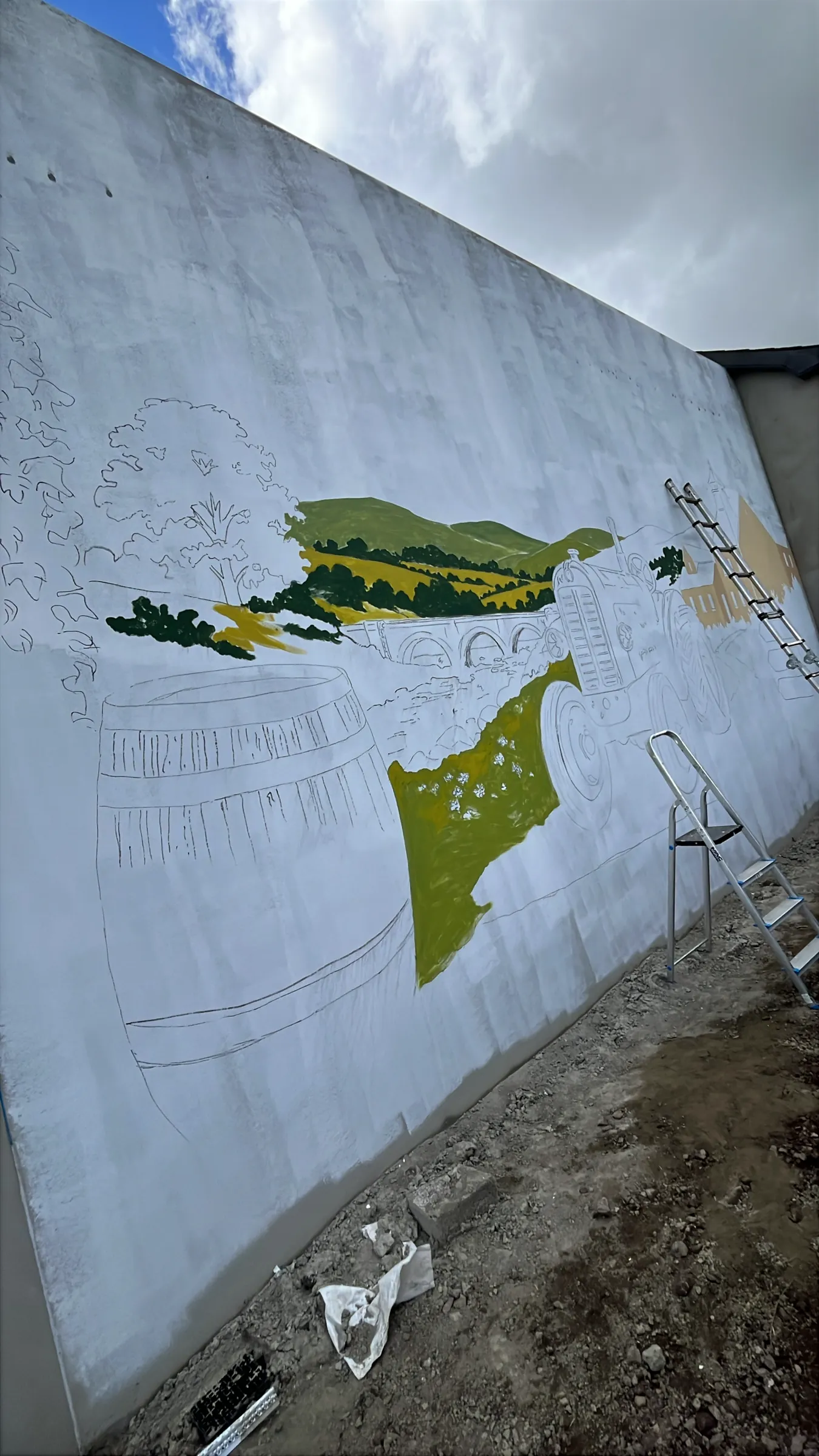 The first green fields going onto the whitewashed gable over the sketched outlines.