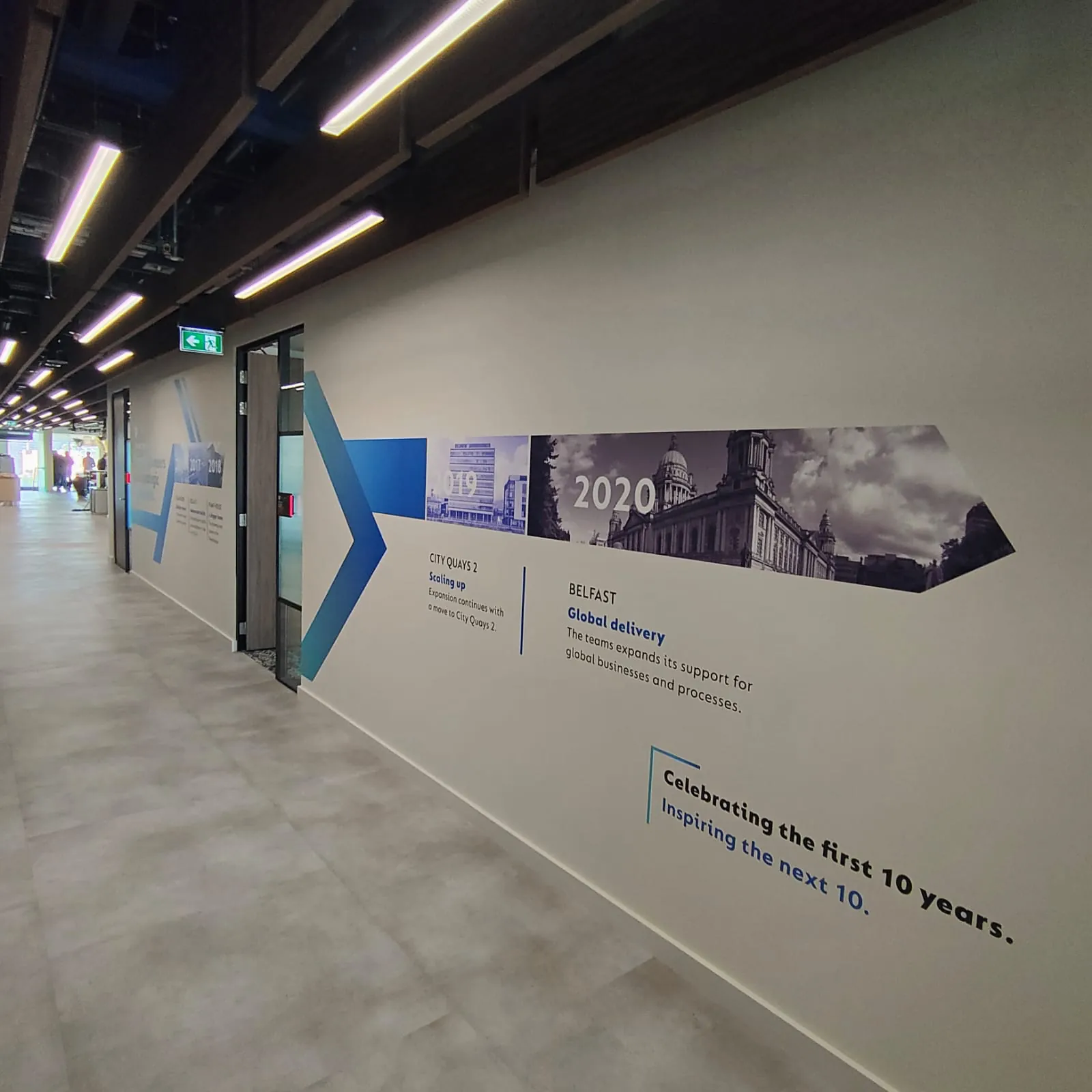 A corridor painted with a timeline of TP ICAP’s Belfast hub, “Celebrating the first 10 years, inspiring the next 10”.